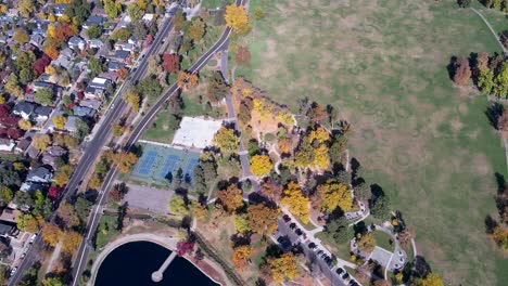 A-4K-drone-shot-over-Washington-Park-and-Tennis-Courts,-Mount-Vernon-Garden,-and-Grasmere-Lake,-in-Denver,-Colorado,-on-a-peaceful-day,-during-the-colorful-Fall-season