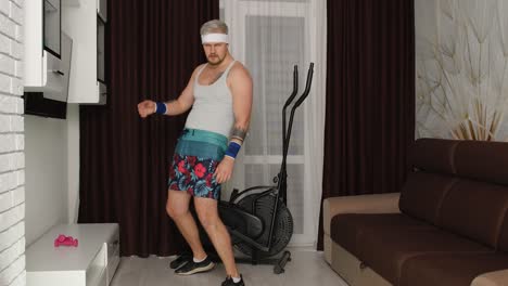 funny fat sportsman man making sport fitness exercise, showing cardio exercises for weight loss