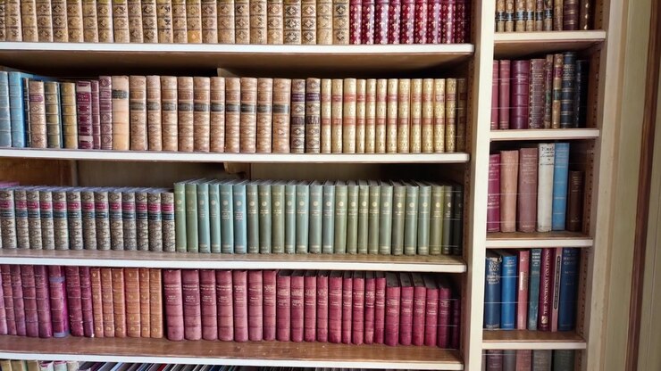 Tilt down on colorful antique bookshelves inside Leeds Castle library