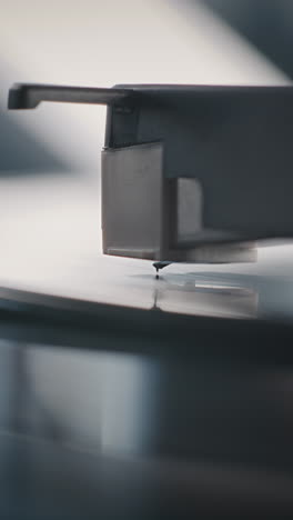 close-up of a record player stylus on a vinyl record