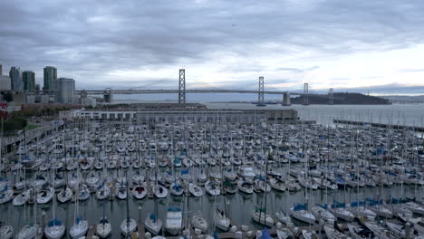 panoramic view of san francisco bay bridge and marina with sailboats