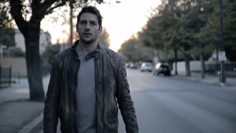 a solitary figure walks down an empty street during twilight, clad in a worn leather jacket, representing moments of introspection and solitude in an urban landscape.
