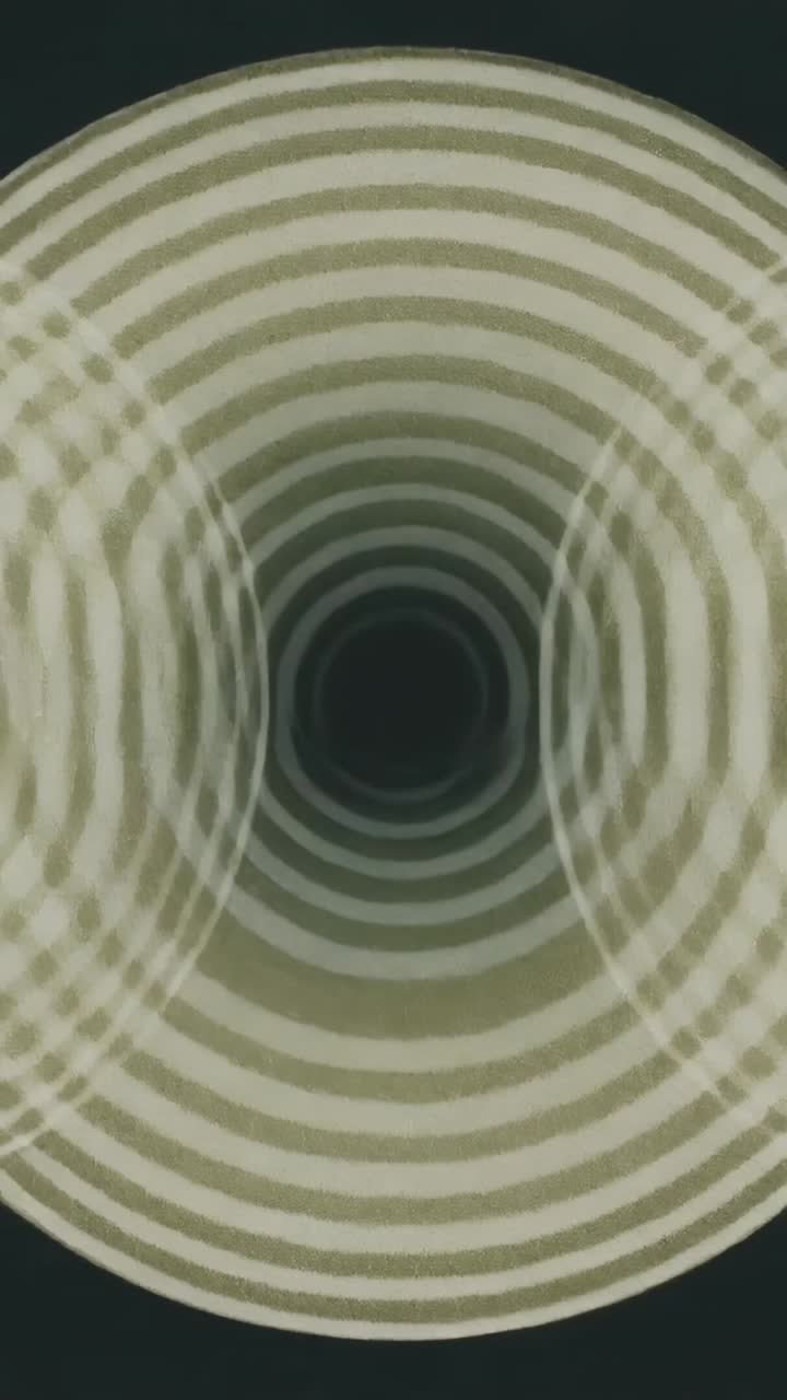 Vertical video: Looping concentric rings pulsing inward on dark screen, showing void and side lobes