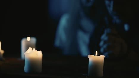Video Capturing a Table with Magical Tools on It A Priest is Sitting at the Table with Beads in His