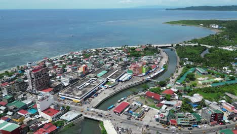 high angle aerial view of seaside town of virac, catanduanes, philippines with busy traffic and open ocean in background