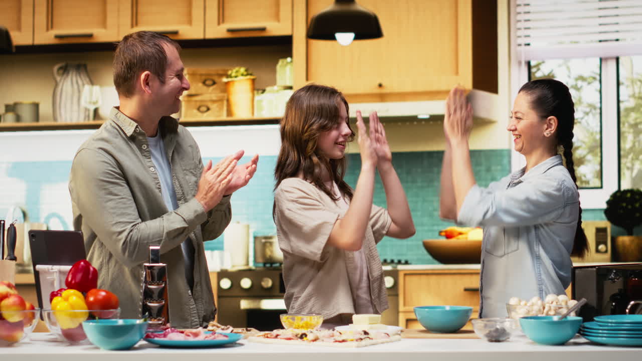 Sweet happy family sharing high five and feeling proud for pizza day