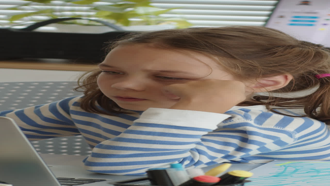 Schoolgirl Doing Test on Laptop at Computer Class