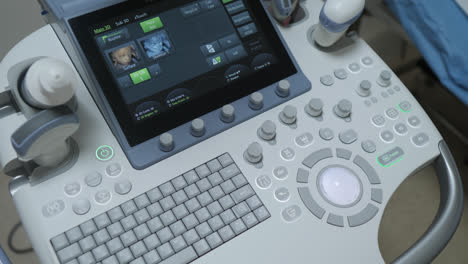 close up of control panel with buttons and screens in an electronic equipment setup