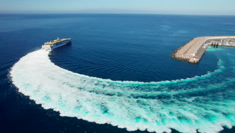 fantastic aerial view of the ferry that leaves the port of agaete and leaves a large wake