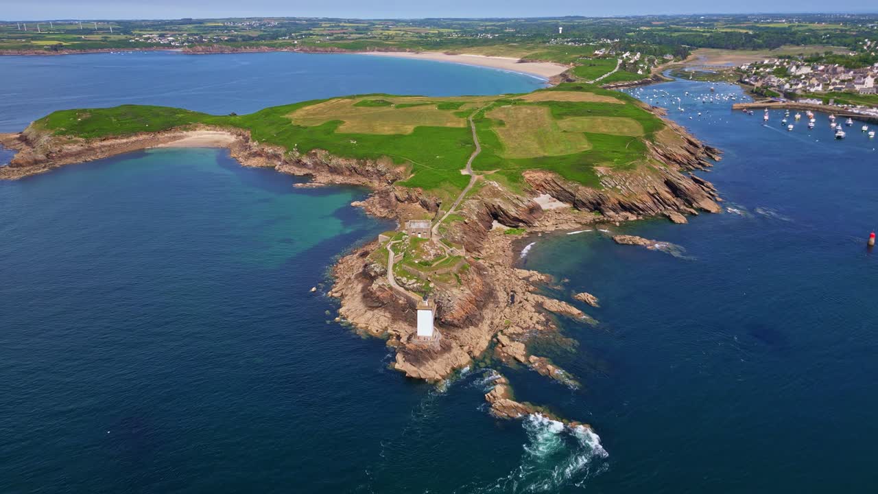 Kermorvan peninsula, historic fort, lighthouse, Le Conquet harbor, and Plage des Blancs Sablons beach in Brittany, France. Aerial forward