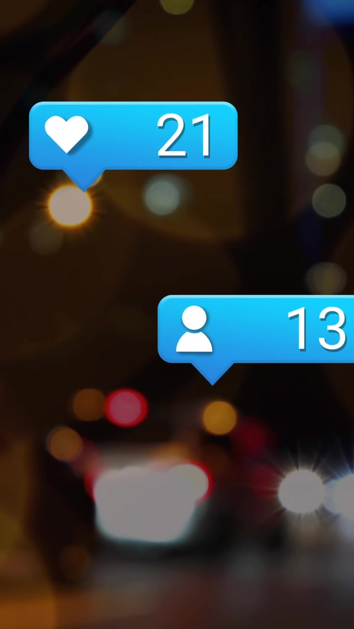 Animation of social media icons and spots of light against blurred view of night city traffic