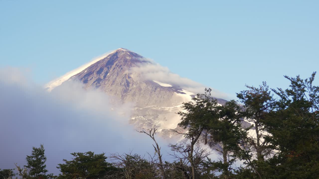 Static shot of Lanín Volcano covered with snow and a blue sky in Neuquén, Argentina.