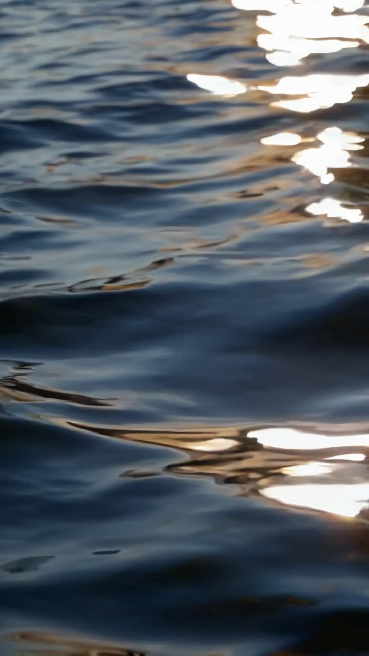 A serene video capturing rippling water with sunlight reflections
