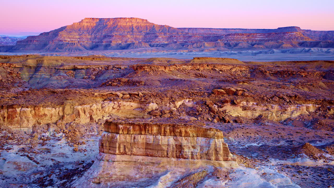 A slow, dramatic drone shot captures the vibrant hills, unique rock formations, and hoodoos near the Utah-Arizona border.