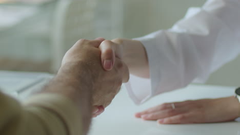 close-up of female doctor giving handshake to patient after consultation