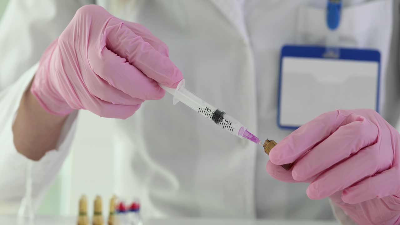 Medical Professional Preparing a Syringe with Medication