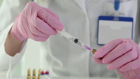 medical professional preparing a syringe with medication