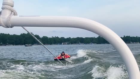 girl tubing behind a boat