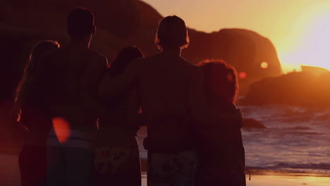 silhouettes of friends looking at the bright sunset