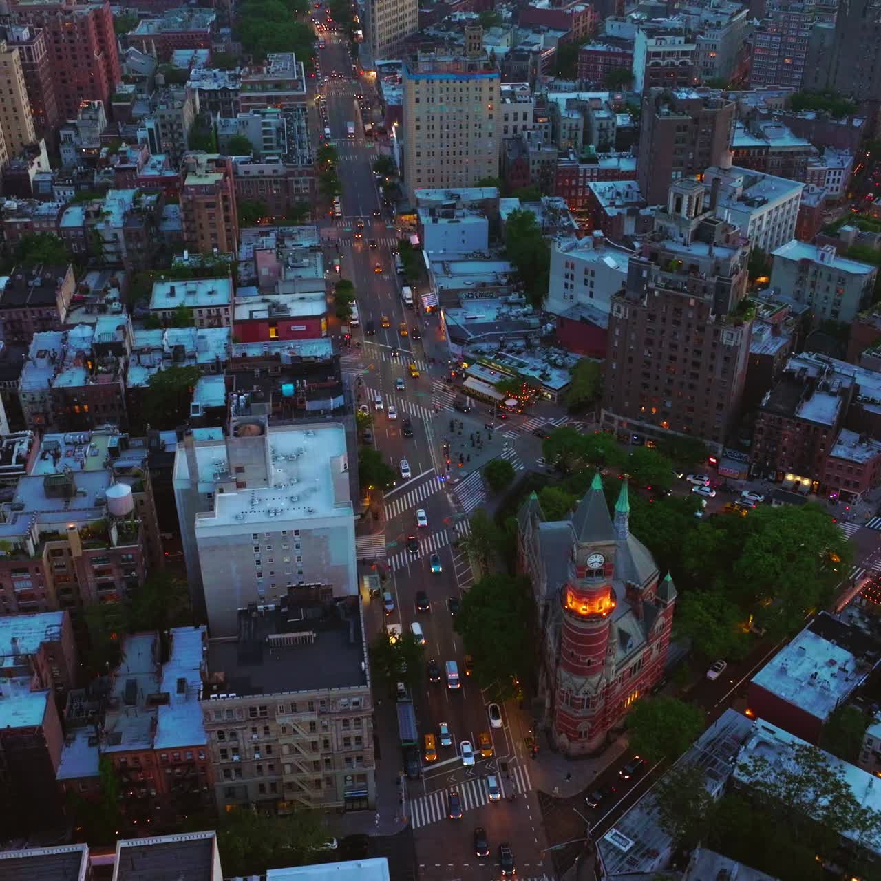 Busy traffic streets crossing the city. Beautiful New York panorama at dusk from aerial perspective