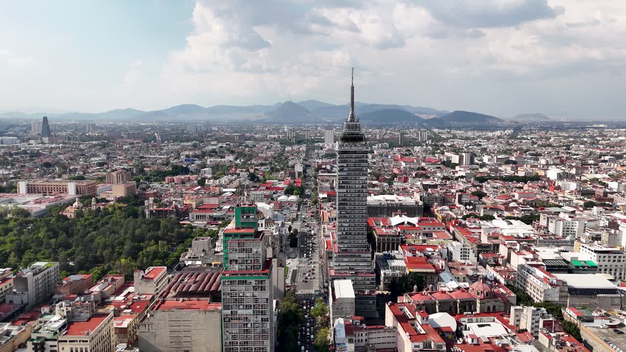 Backwards drone of eje central in mexico city near torre Latino
