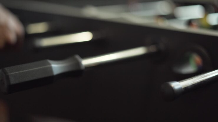 Close-Up Shot of Hands Playing Foosball