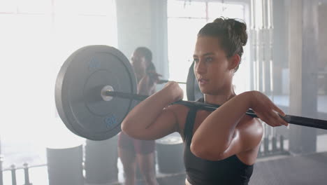 lifting barbells, women exercising in gym, focusing on strength training