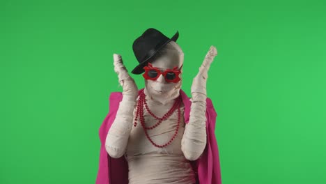 green screen isolated chroma key video capturing a mummy dancing and singing actively into the