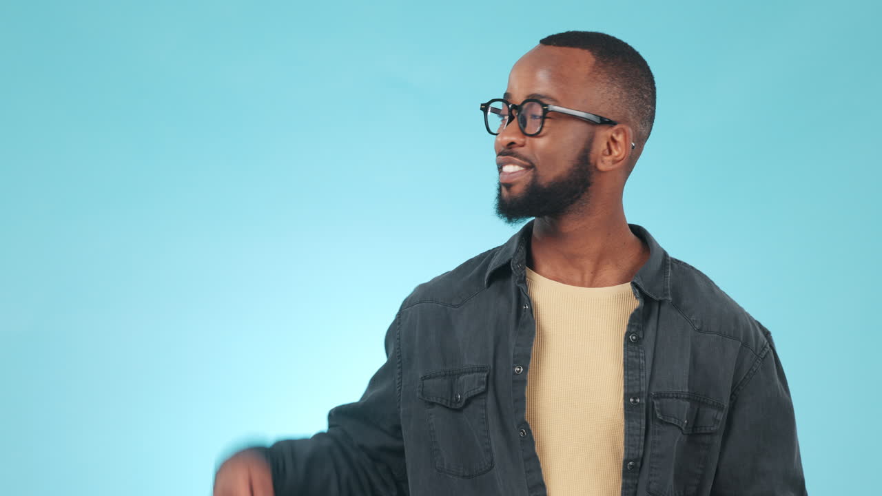 Smile, pointing and face of black man in a studio
