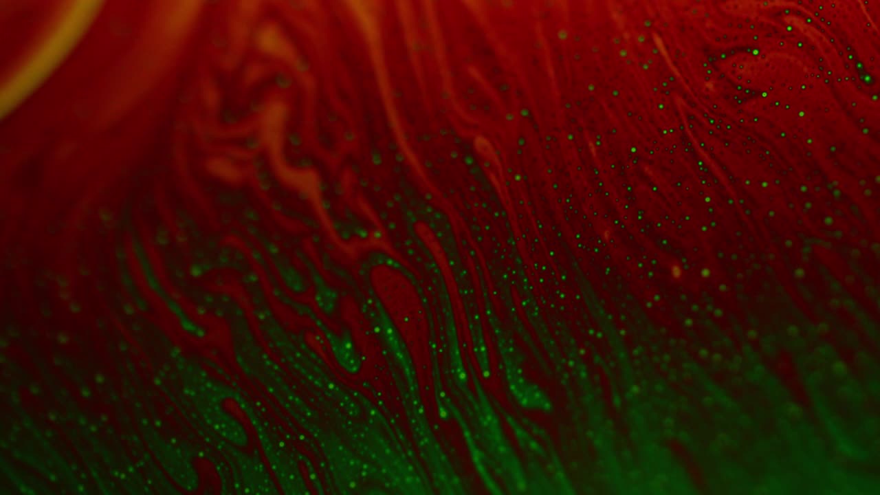 Closeup Shot of Soap Surface in Red and Green Streaks Creating Galaxy Effect