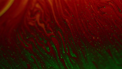 closeup shot of soap surface in red and green streaks creating galaxy effect