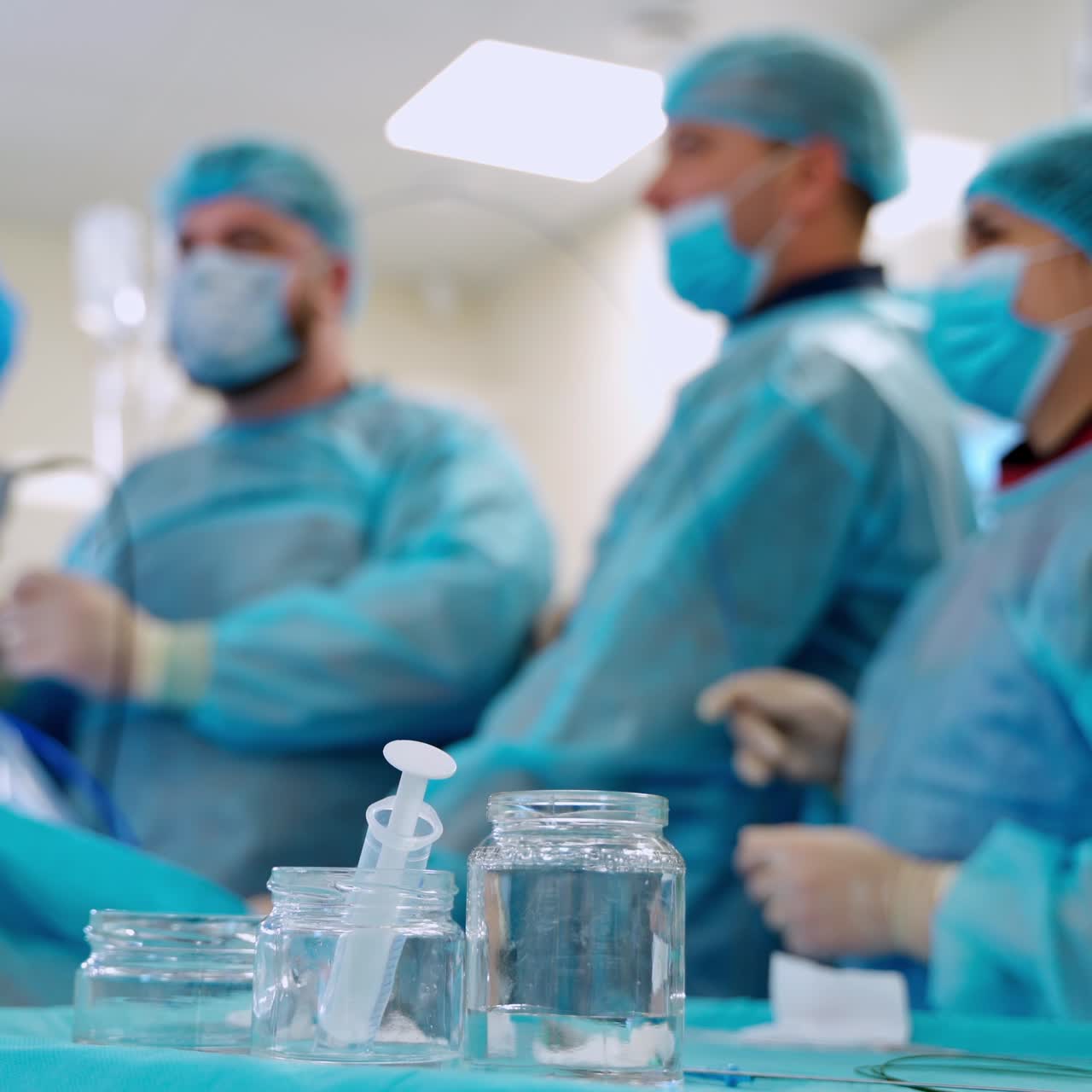 In surgery. Medical team performing operation in hospital operating theater. Working with surgical instruments.