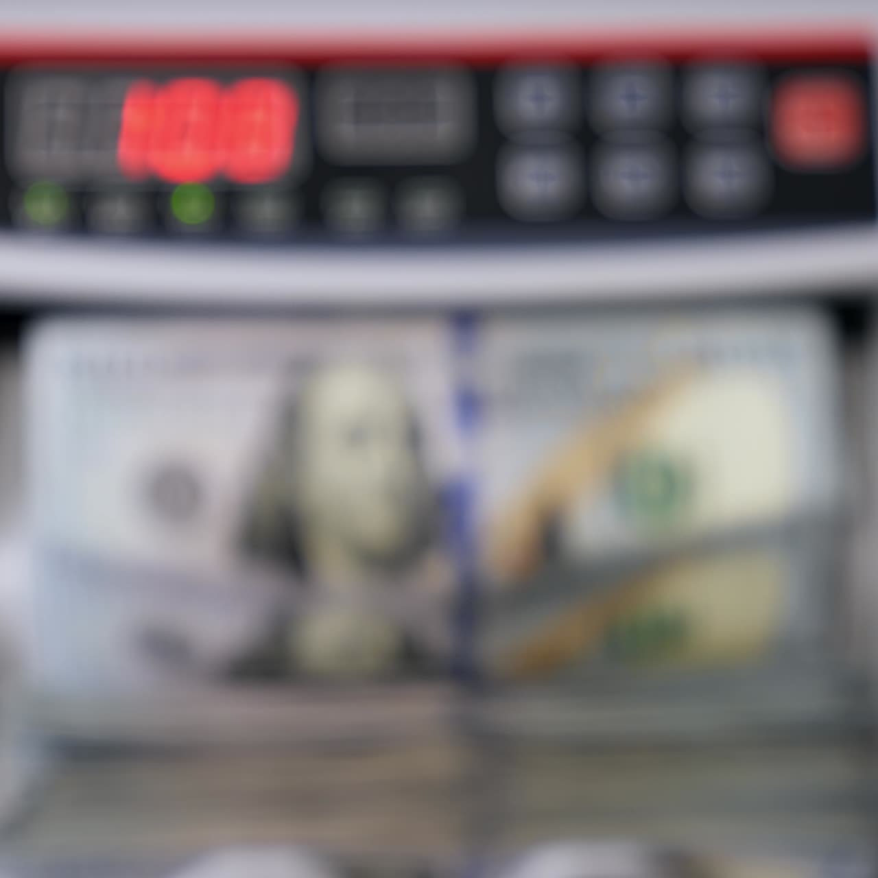 Macchina automatica che conta banconote in dollari. Attività bancaria moderna. Sfondo sfocato. Una mano sta prelevando un pacchetto di banconote in dollari contate dalla macchina contabanconote.