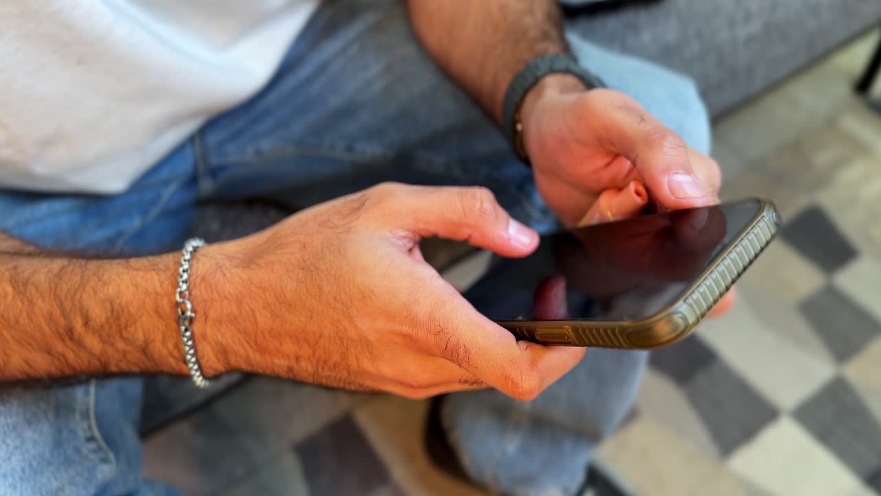 Close-up of hands holding a smartphone in landscape mode, browsing or gaming. Perfect for technology, lifestyle, communication, and modern digital projects