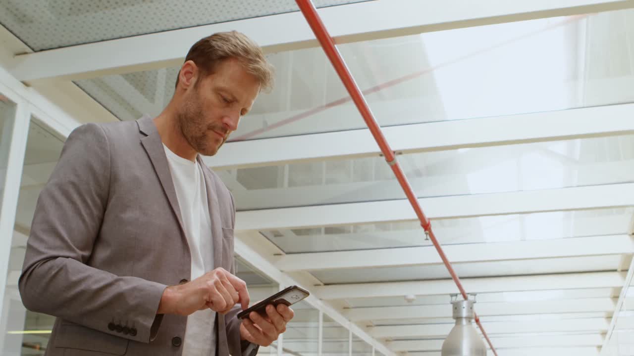 Businessman using mobile in office 4k