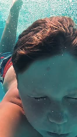 underwater young boy fun in the swimming pool