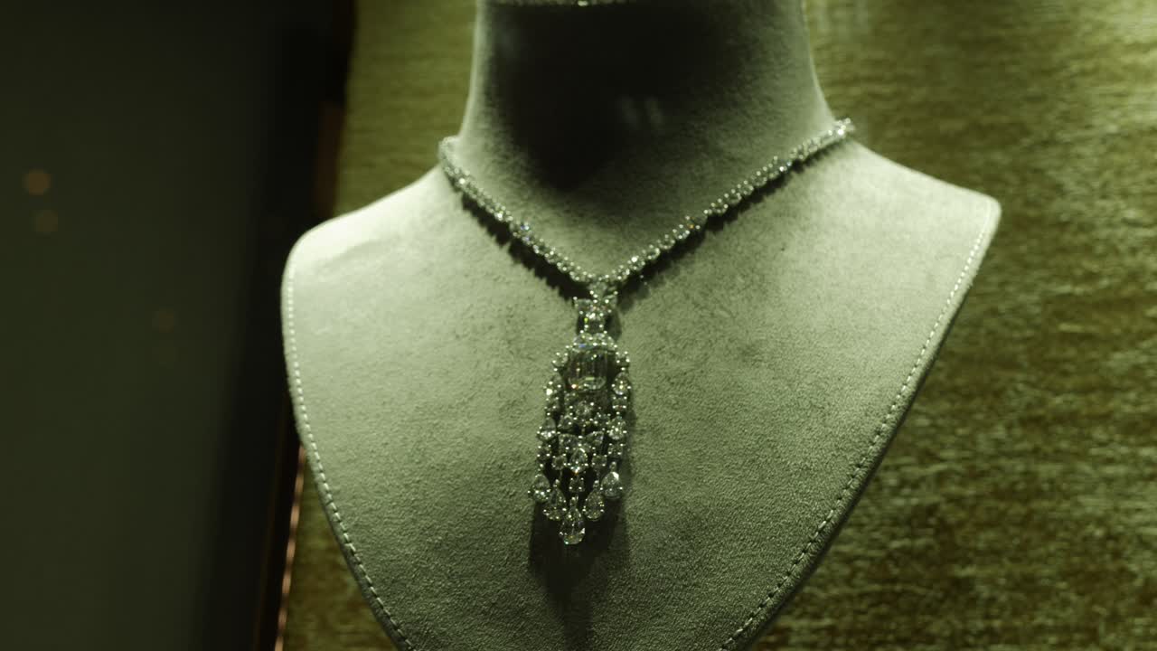 An expensive, beautiful necklace displayed through a window of a jewelry shop in the middle eastern city of Dubai, United Arab Emirates
