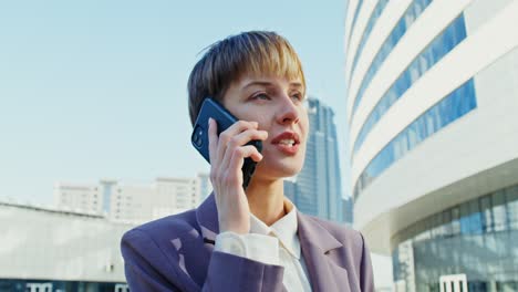 business woman talking on phone in a city