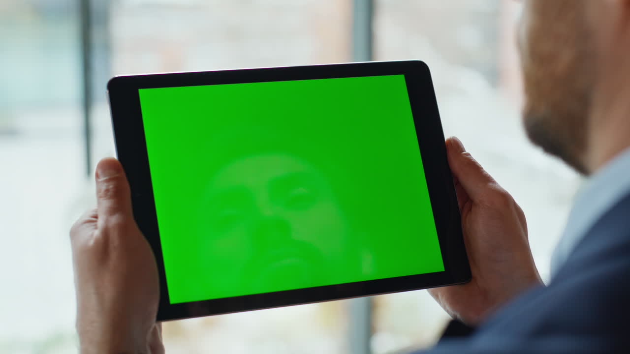 Hands holding mockup tablet browsing internet application closeup. Unknown man