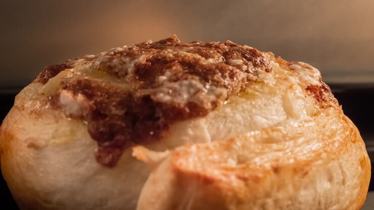Timelapse - homemade cinnamon bun baking and rising in electric oven: close up