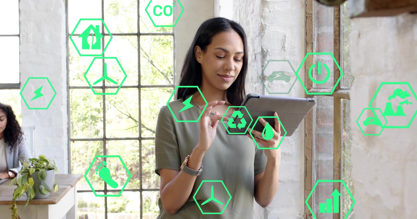 Analista d'ufficio che tocca il tablet e genera una rete di icone ecologiche durante la revisione della dashboard