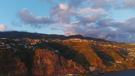 aerial view of calheta, madeira, portugal, during golden hour, with colorful mountain, houses, marina and atlantic ocean