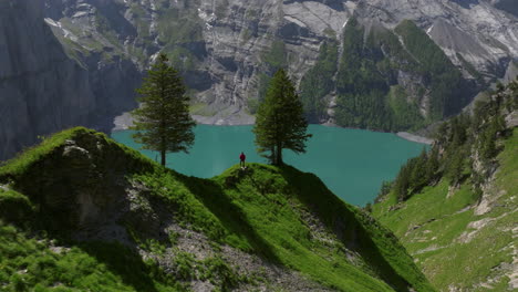 aerial view of a man over mountaintop on oeschinen lake in the bernese oberland, switzerland