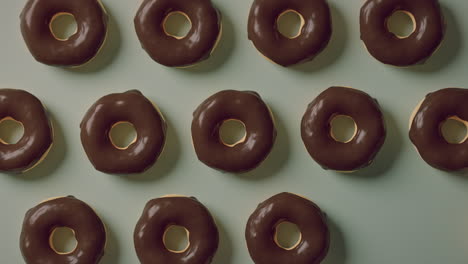 chocolate glaze donuts on a mint background