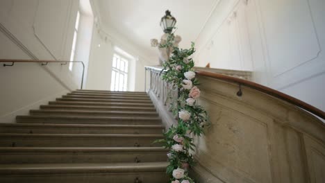 grand staircase in an old building decorated with flowers