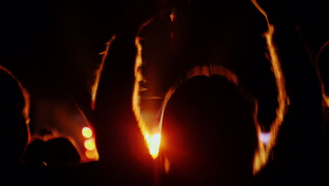 woman with two teenage children having fun at a rock concert dancing and actively applauding 4k 10 b