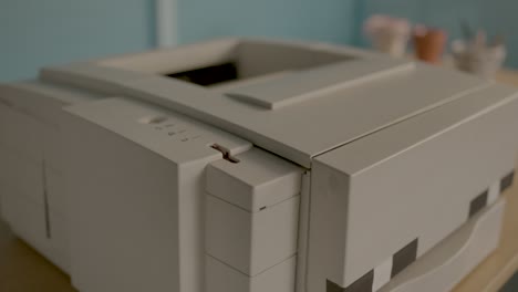 red warning light flashes on and off on an old printer, static close up