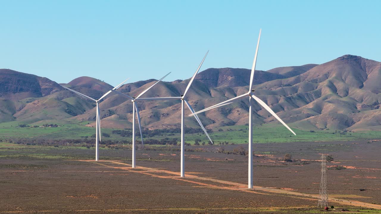 Aerial telephoto shot of wind turbines with hills near Port Augusta, South Australia