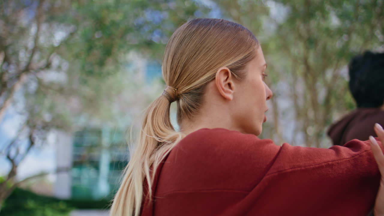 Urban athlete stretching hands before training outdoors. Closeup girl