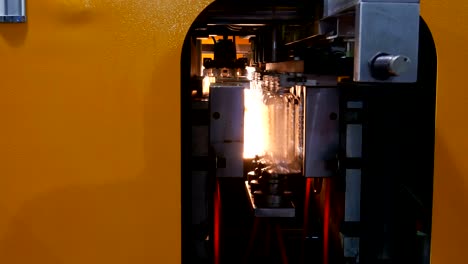 plastic water bottles on a bottle machine and equipment in a factory